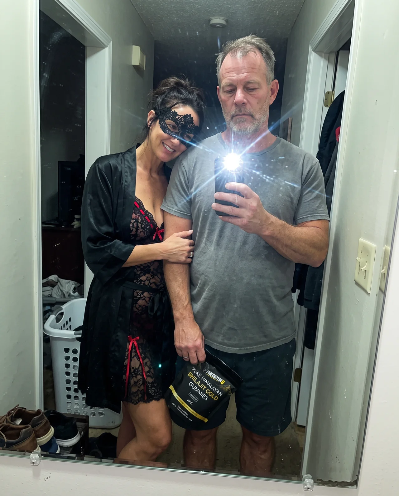 Couple holding a PREDATOR8 pouch at home