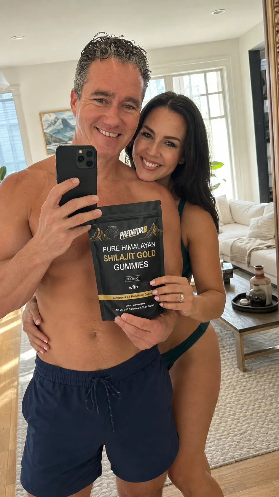 Couple taking a mirror selfie in the living room with a PREDATOR8 pouch